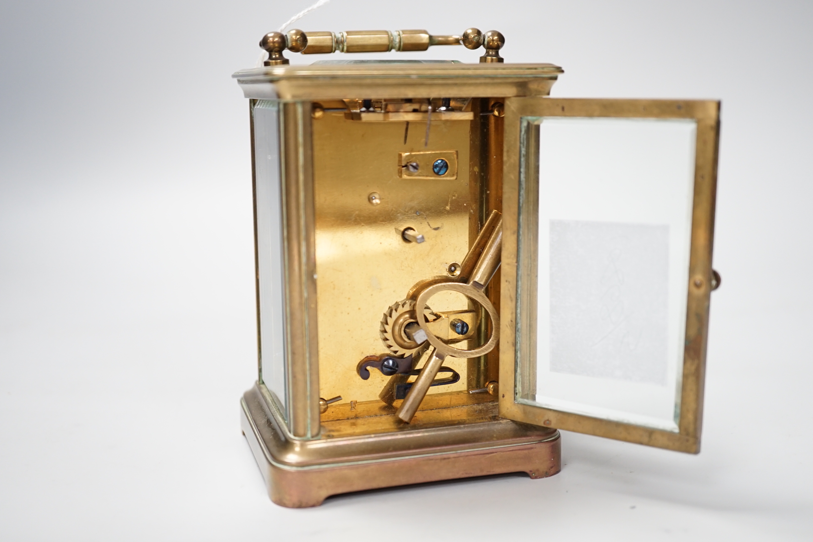 A French brass cased timepiece with silvered and enamelled dial, 12cm tall